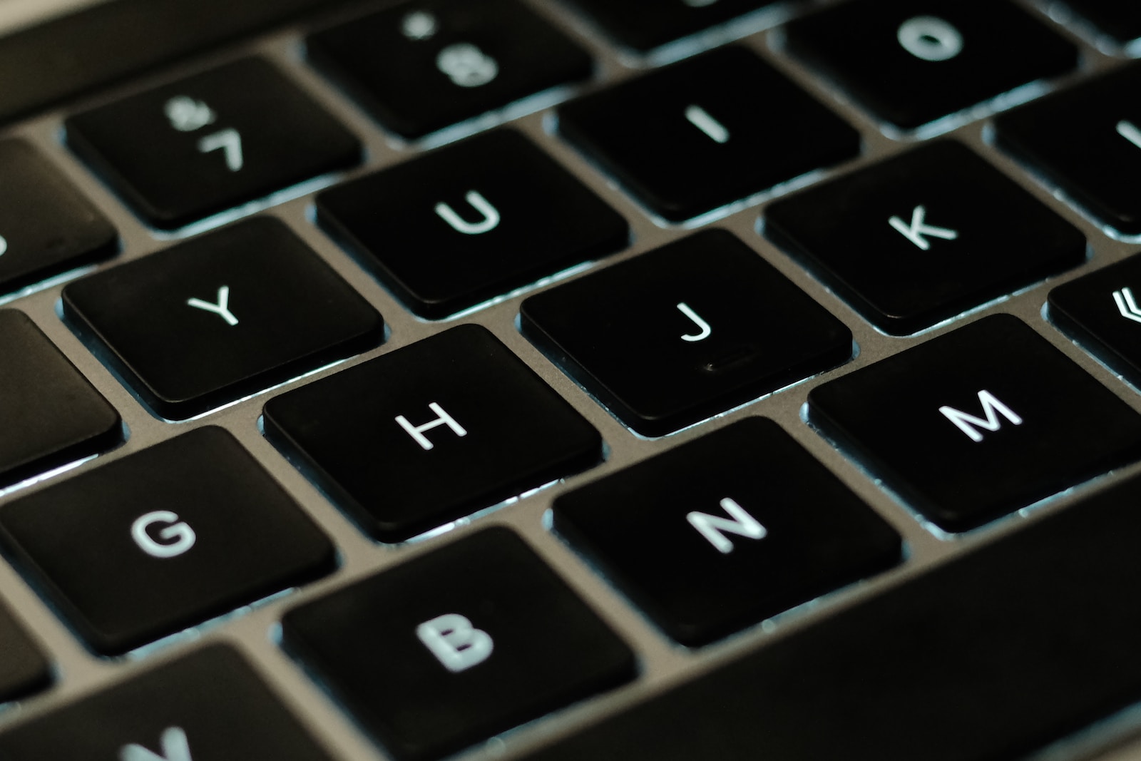 a close up of a black keyboard with white letters